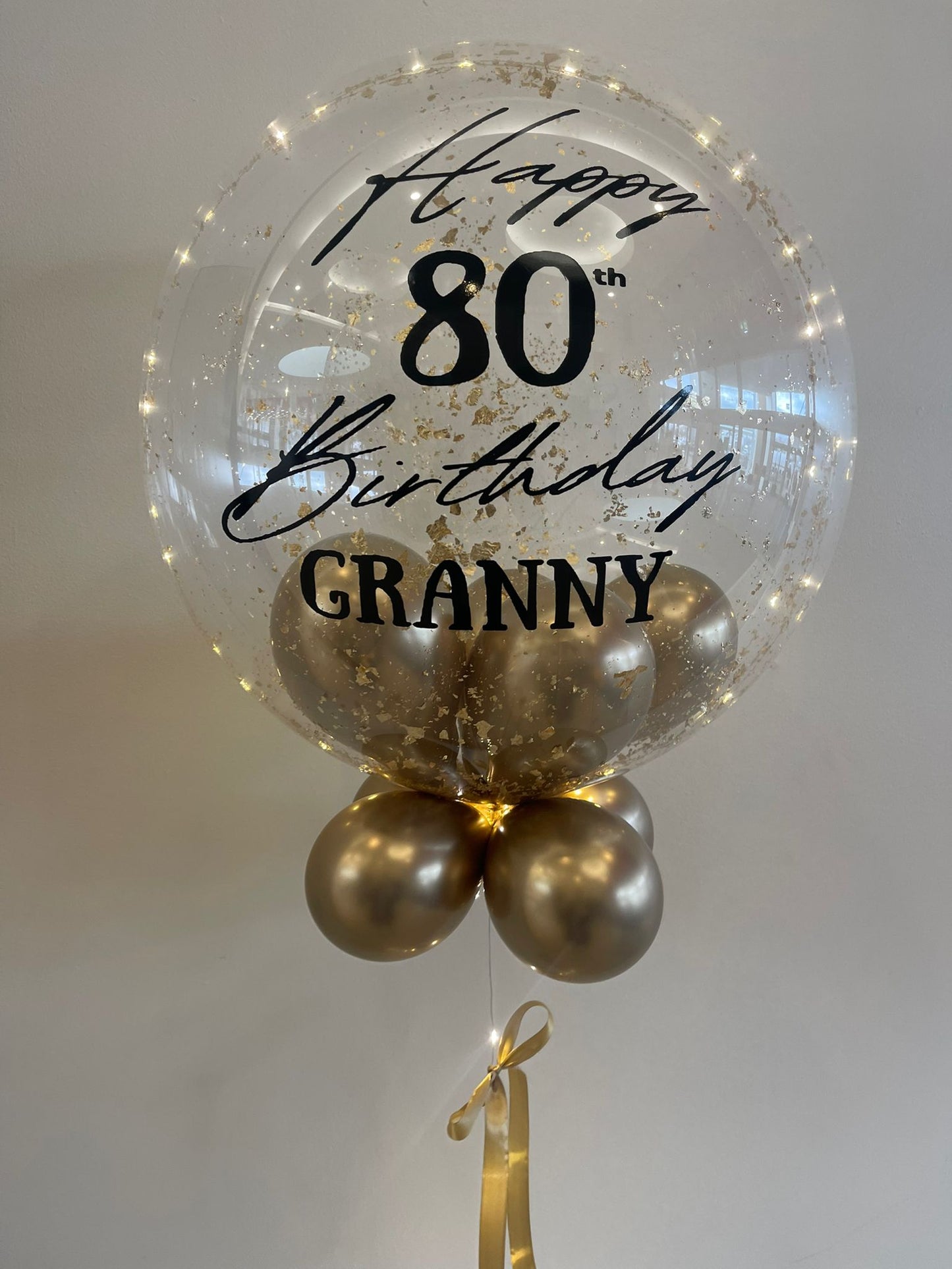 Personalised Clear Bubble with Gold Flakes & LED Lights – Gold Smallies, Black Vinyl, Gold Bow